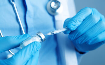 a doctor holding a syringe ready to give a vaccine injection