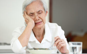 Disappointed old elderly people eating overnight food,she's sick of food,tired of eating same food,lacking flavor,Asian senior woman suffering from anorexia,loss of appetite,diet and nutrition concept