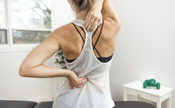 woman at physiotherapy center having hurting back