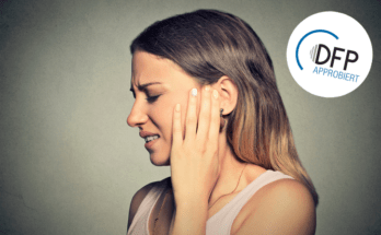 Tinnitus. Closeup side profile sick young woman having ear pain touching her painful head isolated on blue background