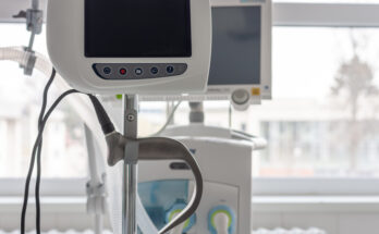 Video laryngoscope , on background medical ventilator in ICU in hospital. Video laryngoscope with separate screens to keep doctors away from patients.